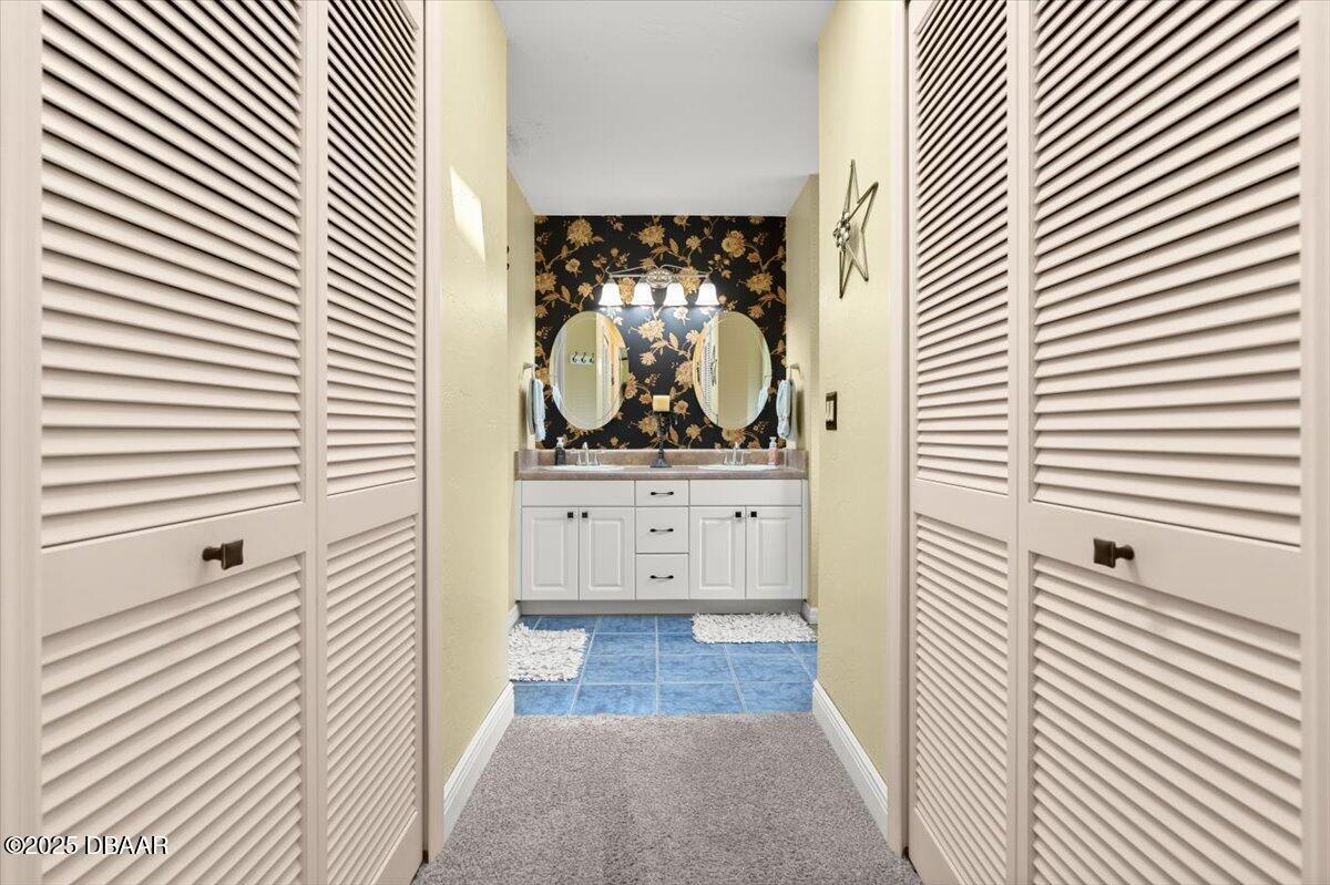1005 North Kepler Road DeLand, FL 32724 - Photo 32 of 57 a bathroom with a sink a mirror and a shower