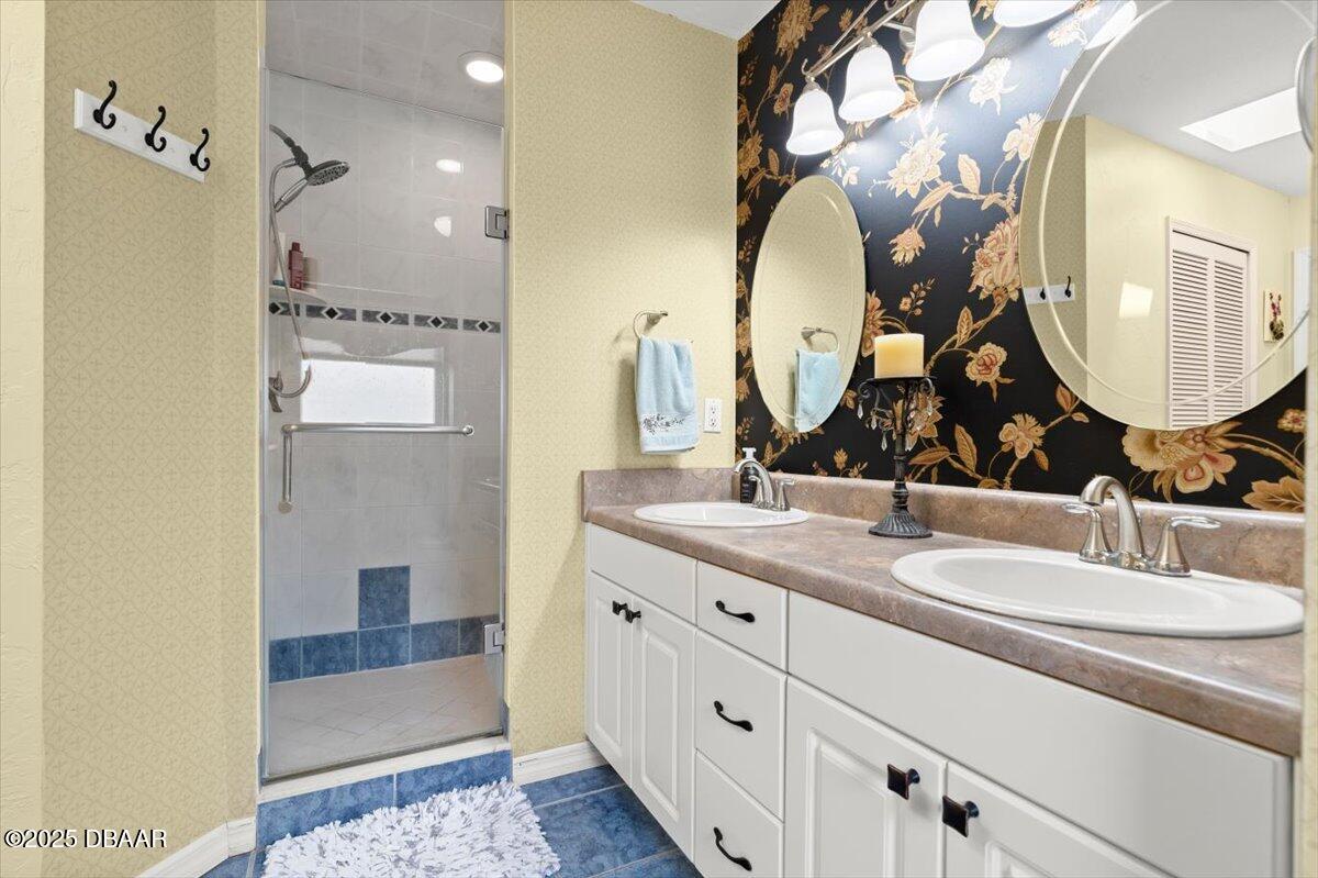 1005 North Kepler Road DeLand, FL 32724 - Photo 34 of 57 a bathroom with a double vanity sink and a mirror