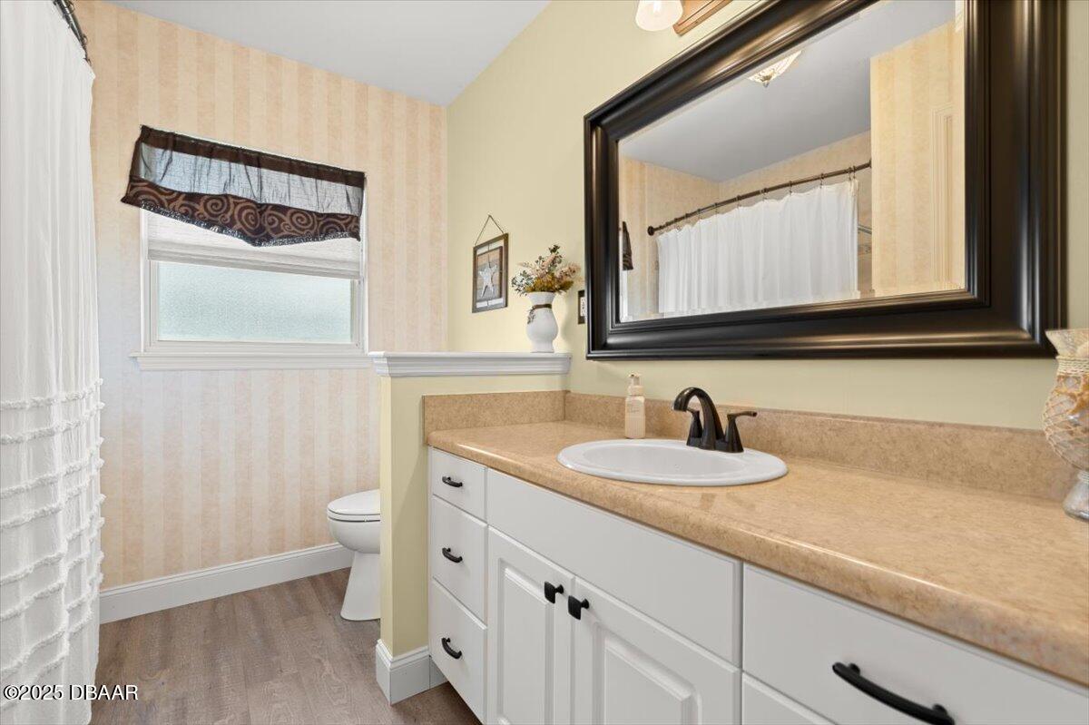 1005 North Kepler Road DeLand, FL 32724 - Photo 37 of 57 a bathroom with a granite countertop sink and a mirror
