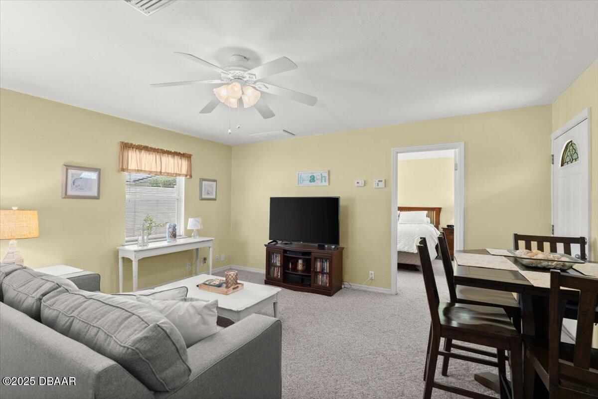 1005 North Kepler Road DeLand, FL 32724 - Photo 40 of 57 a living room with furniture and a flat screen tv