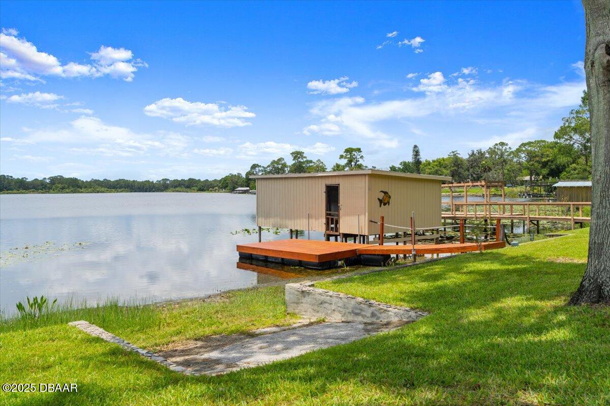 1005 North Kepler Road DeLand, FL 32724 - Photo 48 of 57 a view of a lake with lawn chairs and a table