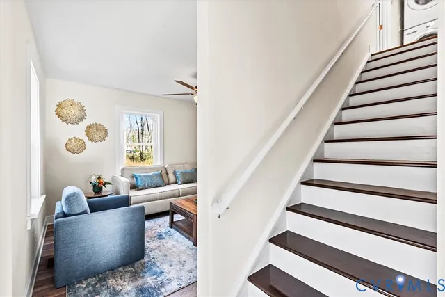 a living room with furniture and stairs