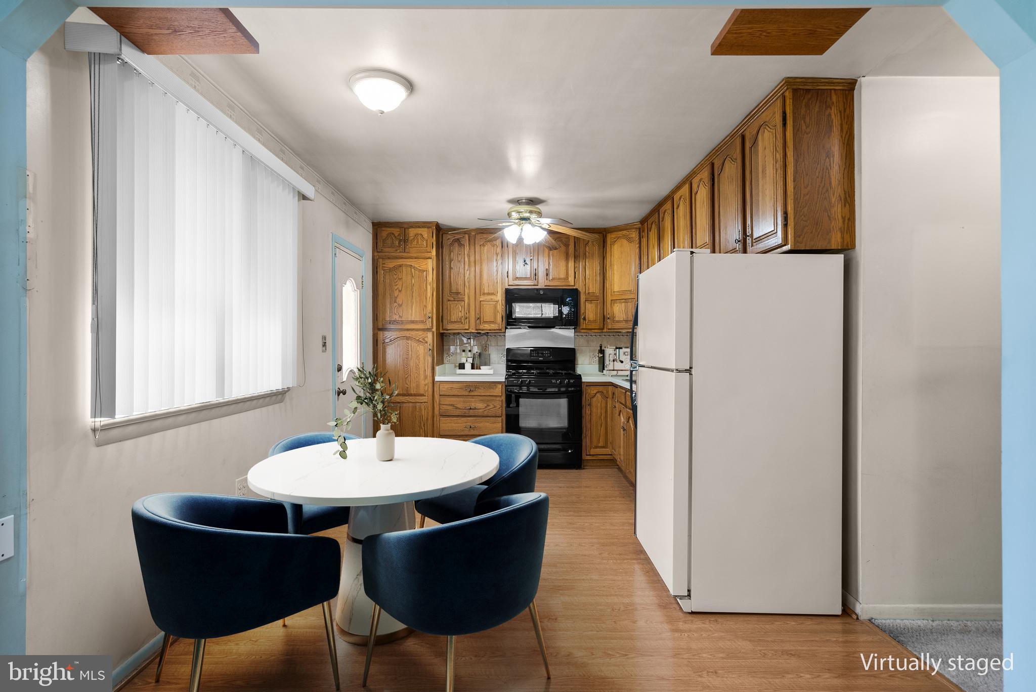 11411 Indigo Drive Beltsville, MD 20705 - Photo 13 of 40 a kitchen with refrigerator and chairs