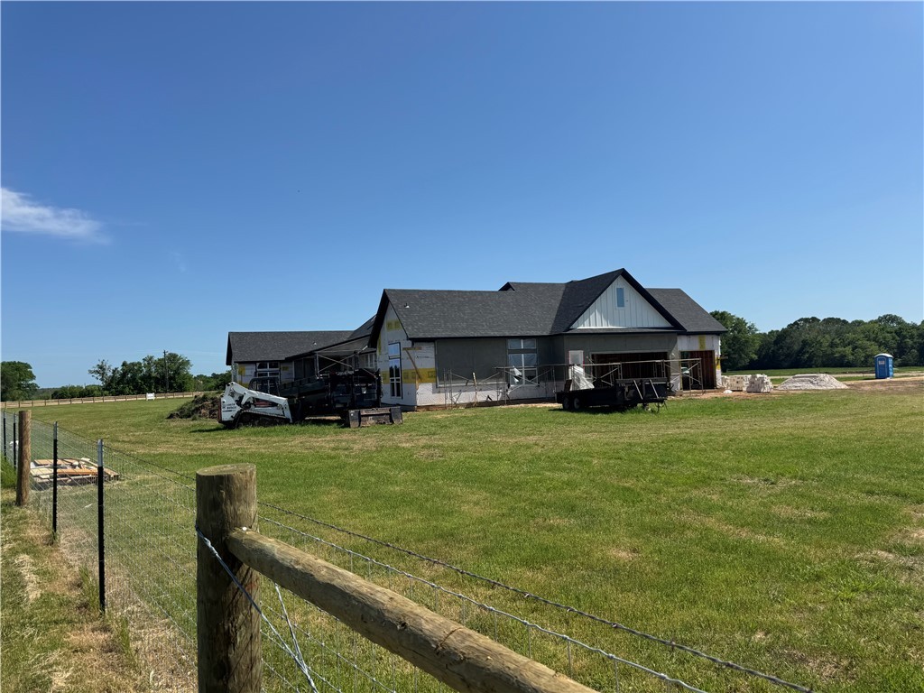 13504 Hudson Farms Road Hearne, TX 77859 - Photo 27 of 32 Back of property with a lawn, fence, and roof with