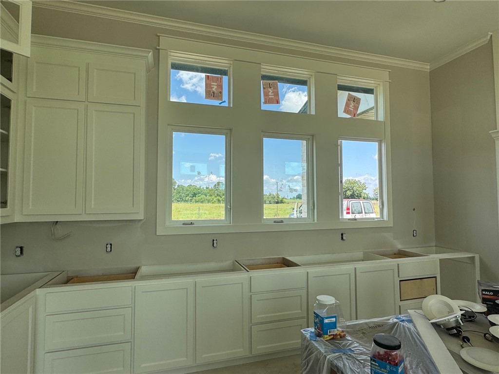 13504 Hudson Farms Road Hearne, TX 77859 - Photo 6 of 32 Kitchen featuring white cabinetry and ornamental m