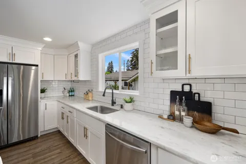 a kitchen with a sink cabinets and stainless steel appliances