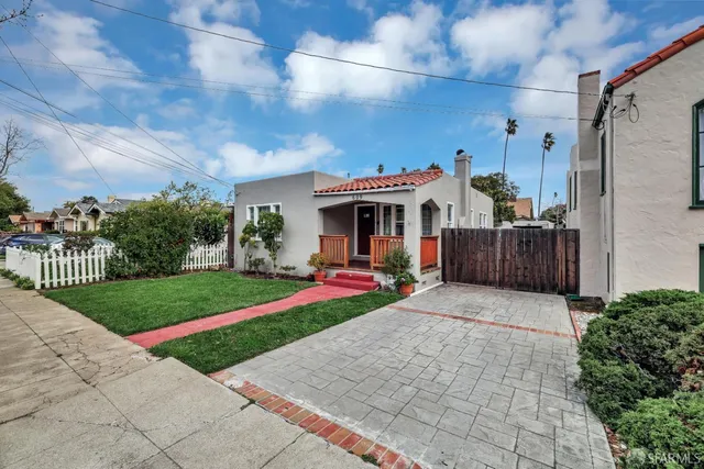 a front view of a house with swing and a table