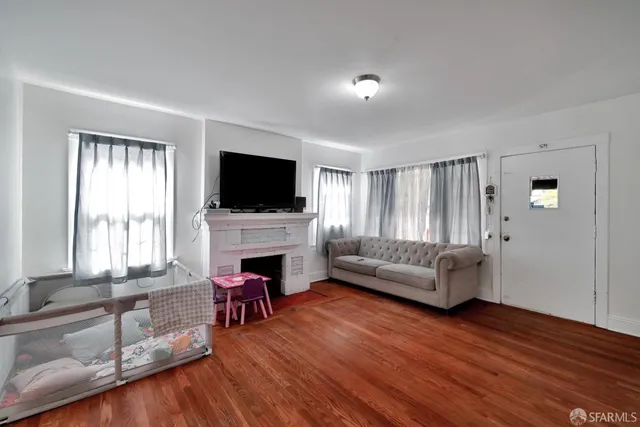 a living room with fireplace furniture and a flat screen tv