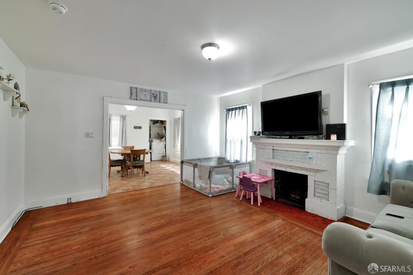 609 South Delaware Street San Mateo, CA 94402 - Photo 9 of 22 a living room with furniture a flat screen tv and a fireplace