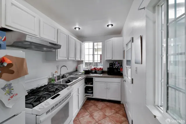 a kitchen with a sink stove and refrigerator