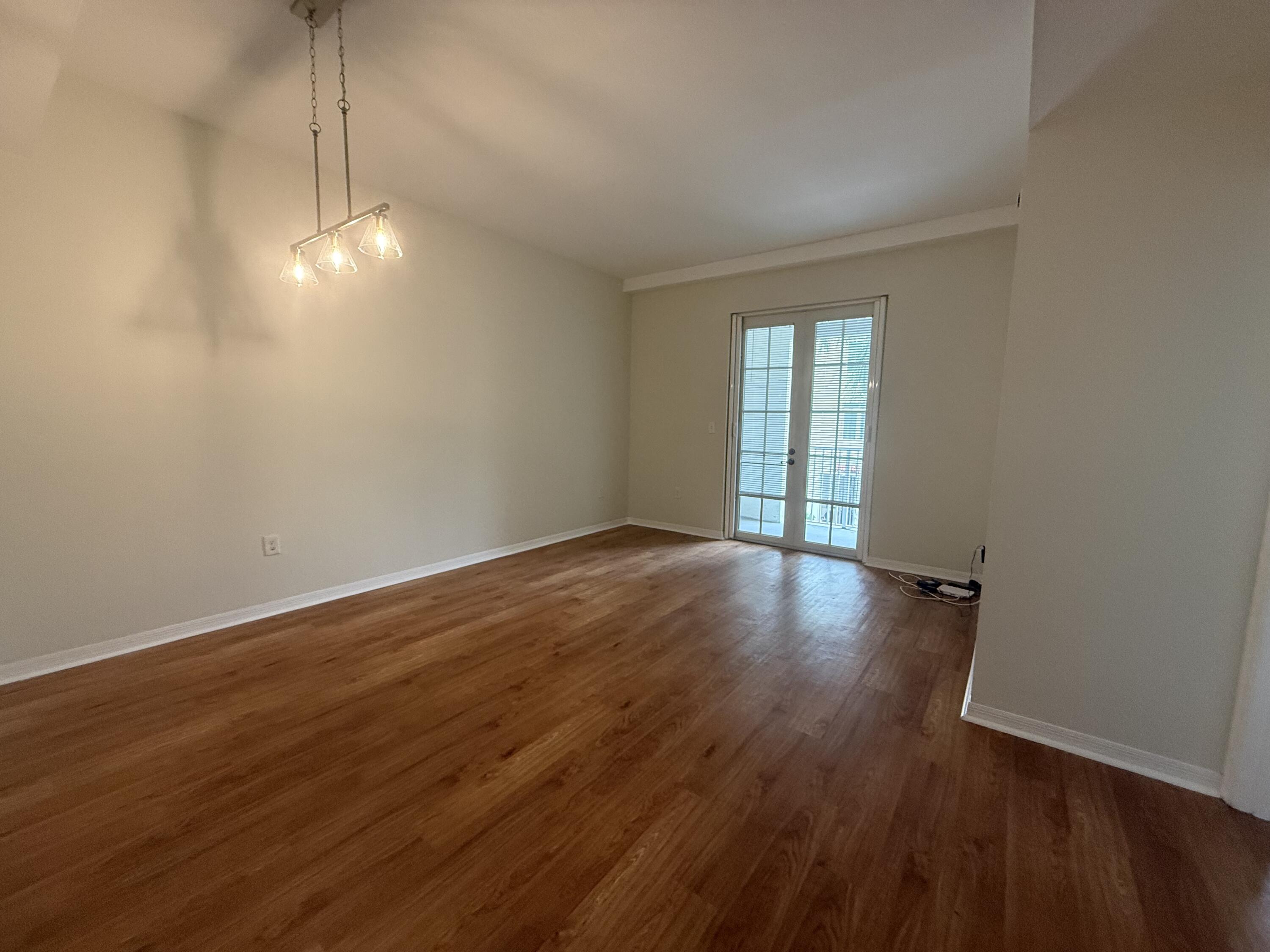 1200 Town Center Drive, Unit 206 Jupiter, FL 33458 - Photo 14 of 24 a view of empty room with wooden floor and fan