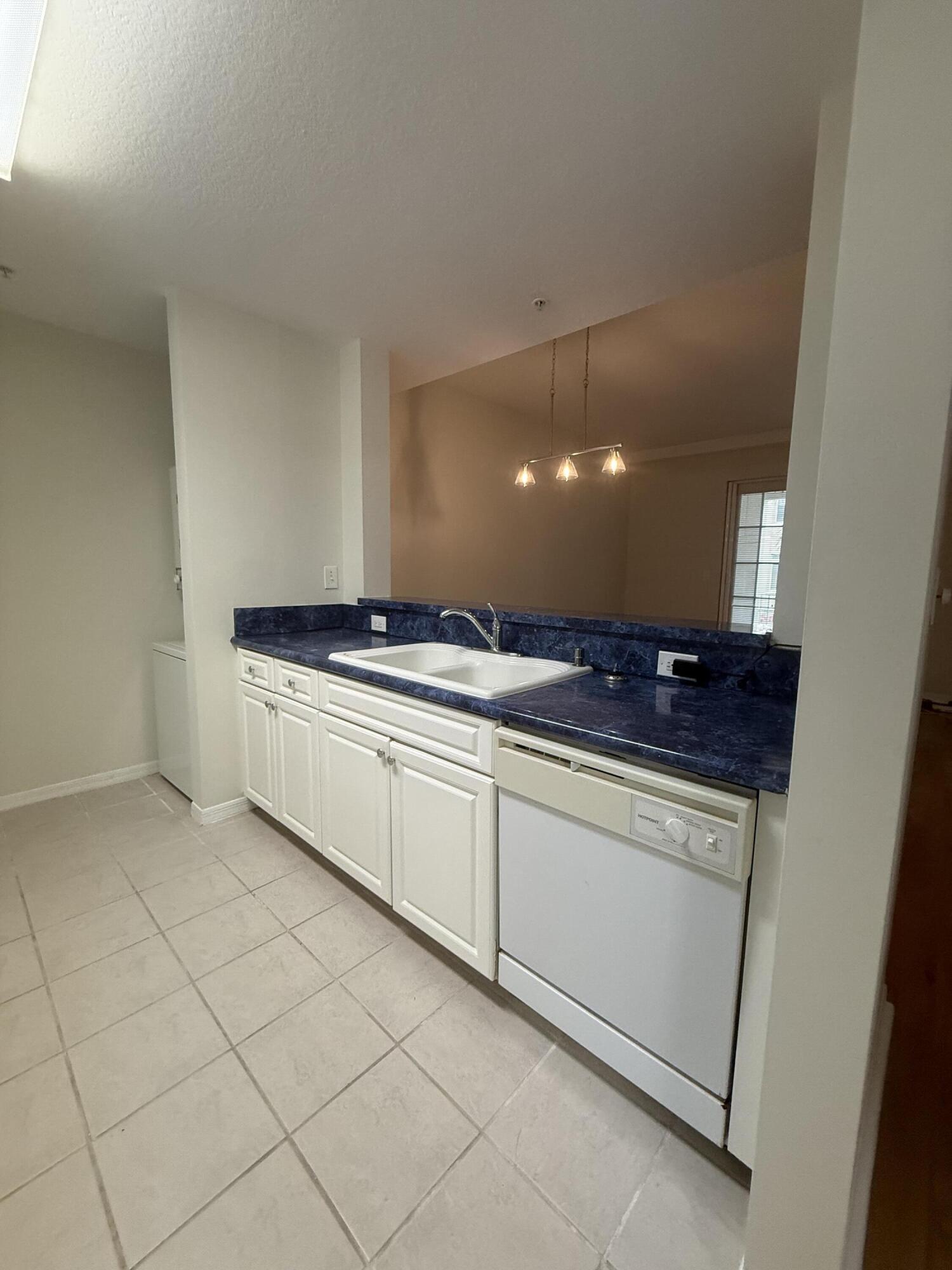 1200 Town Center Drive, Unit 206 Jupiter, FL 33458 - Photo 17 of 24 a kitchen with a sink and cabinets