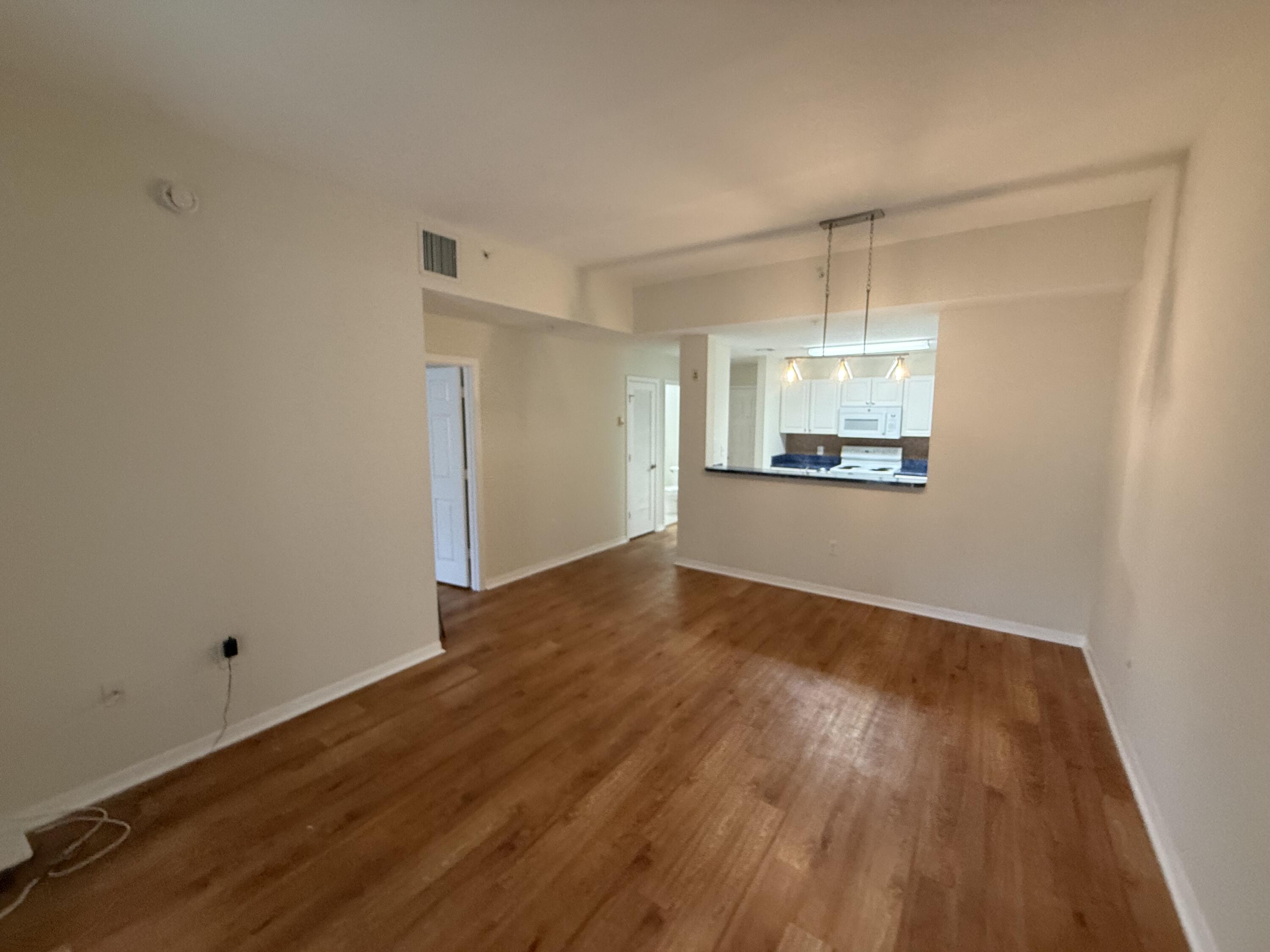 1200 Town Center Drive, Unit 206 Jupiter, FL 33458 - Photo 8 of 24 a view of a room with wooden floor and window