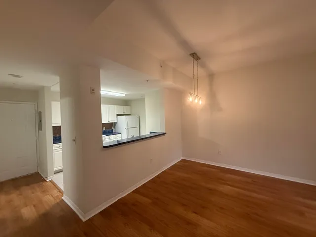 a view of a room with wooden floor and a window