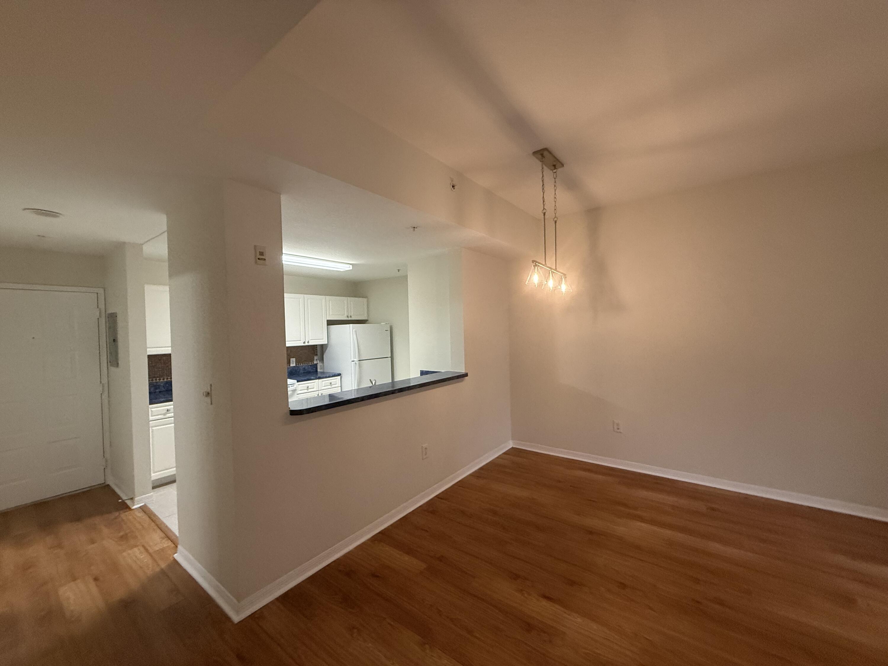 1200 Town Center Drive, Unit 206 Jupiter, FL 33458 - Photo 9 of 24 a view of a room with wooden floor and a window