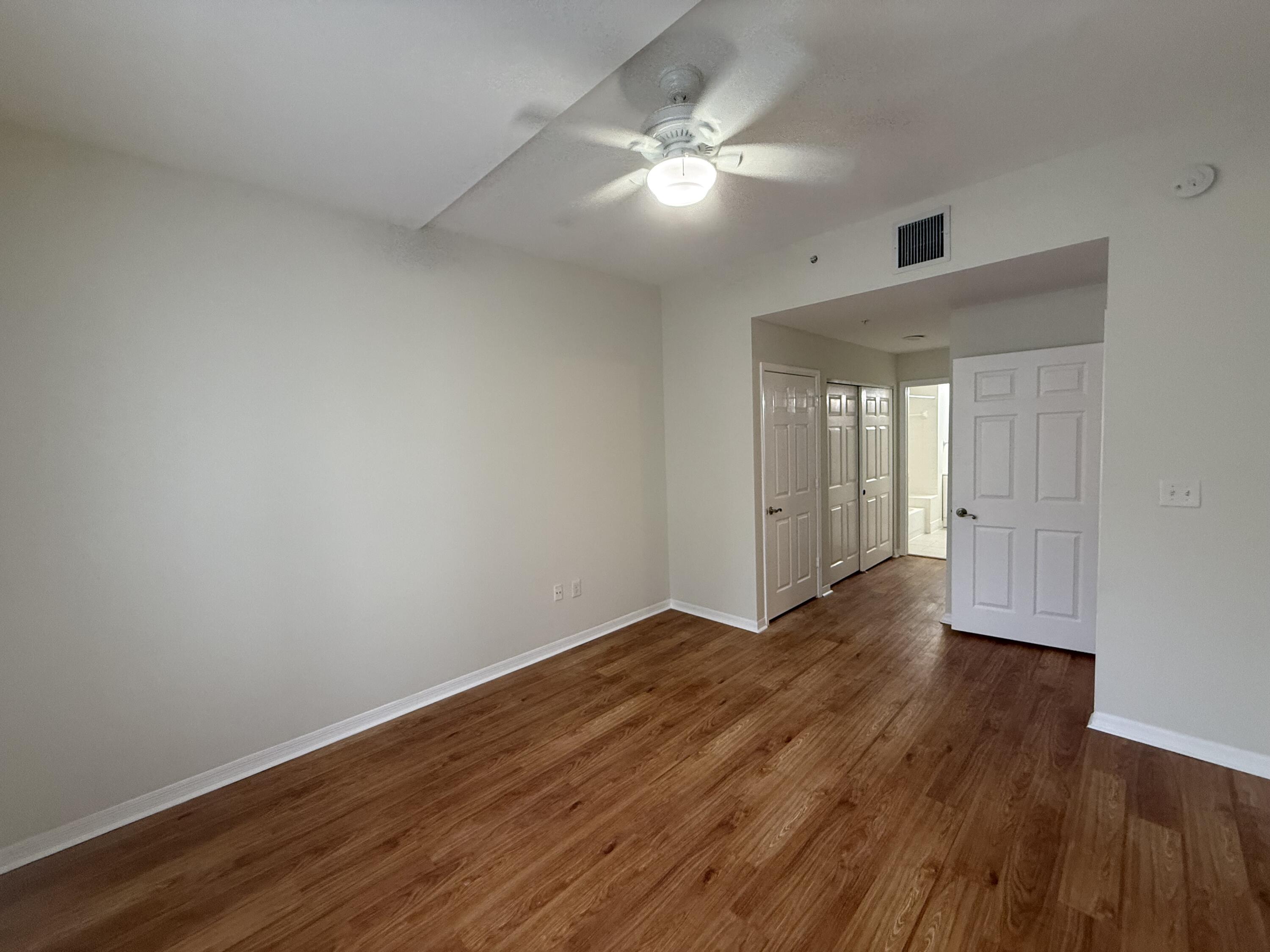 1200 Town Center Drive, Unit 206 Jupiter, FL 33458 - Photo 10 of 24 a view of an empty room with wooden floor