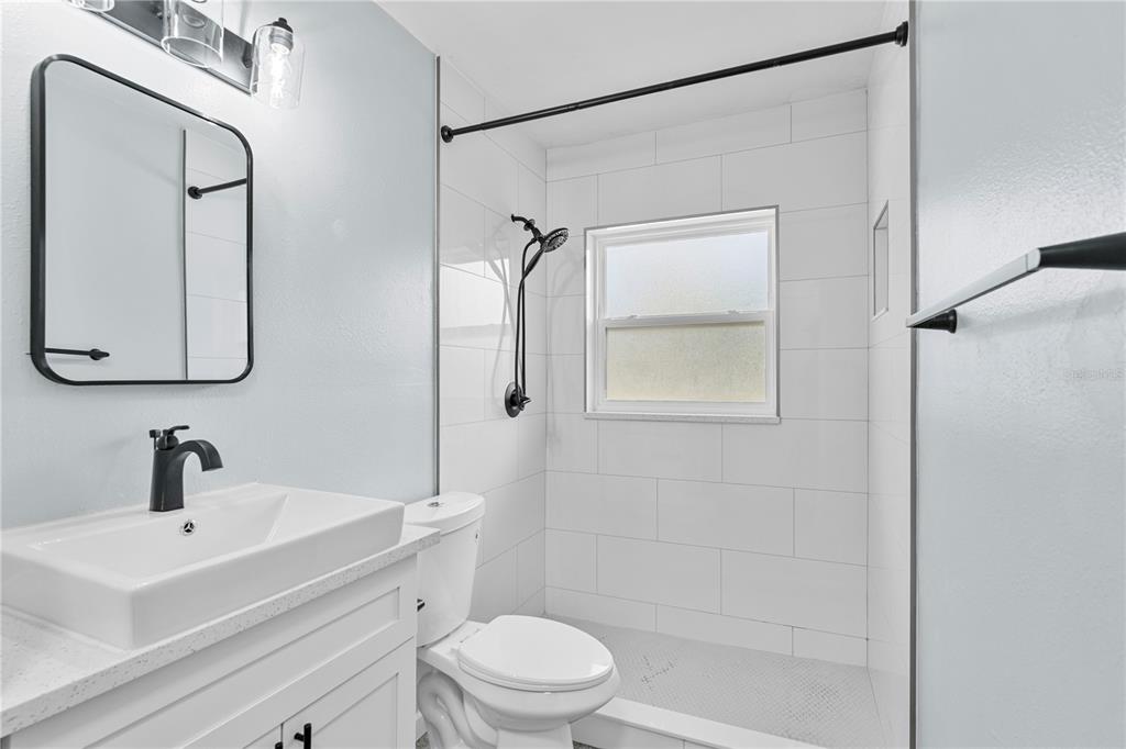 11987 Maple Street, Unit 1 Dunnellon, FL 34432 - Photo 11 of 25 a bathroom with a sink a toilet and shower