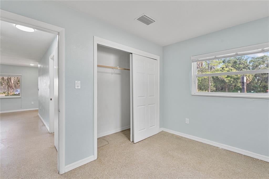 11987 Maple Street, Unit 1 Dunnellon, FL 34432 - Photo 19 of 25 an empty room with windows and closet