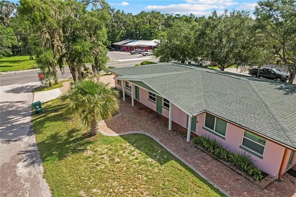 an aerial view of a house with a yard