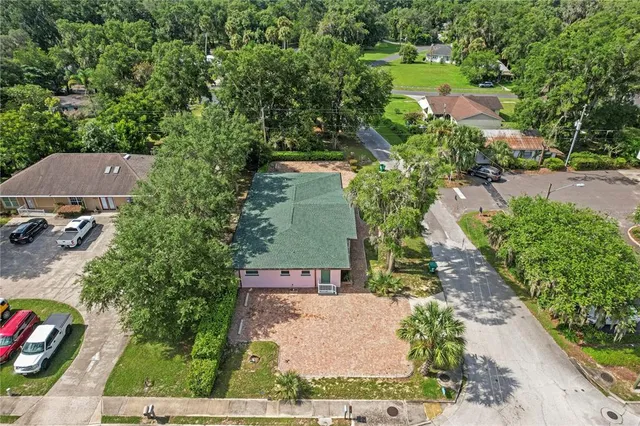 an aerial view of a house with a yard