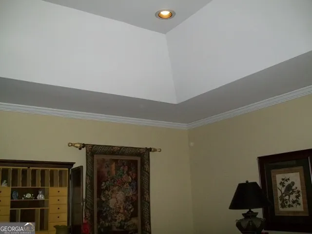 a room with stainless steel appliances wooden floor and a refrigerator