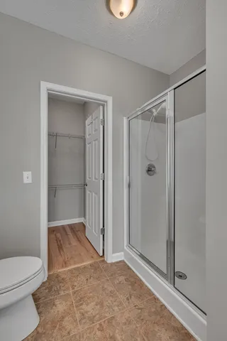 a bathroom with a shower and a toilet