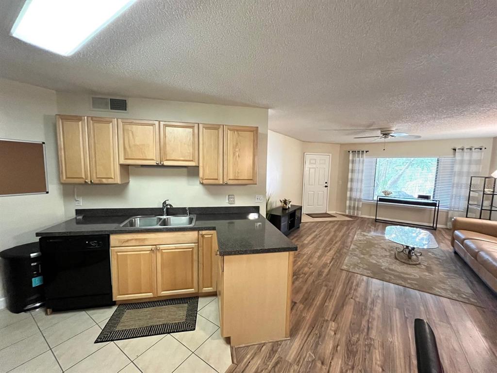 1550 South Belcher Road, Unit 524 Clearwater, FL 33764 - Photo 11 of 45 a kitchen with granite countertop a stove a sink a refrigerator and white cabinets