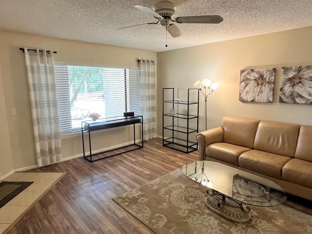 1550 South Belcher Road, Unit 524 Clearwater, FL 33764 - Photo 13 of 45 a living room with furniture a large window and a chandelier