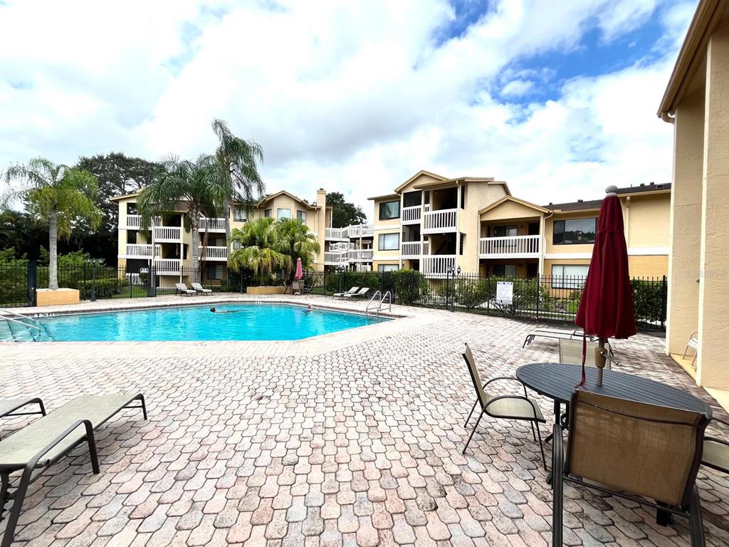 1550 South Belcher Road, Unit 524 Clearwater, FL 33764 - Photo 31 of 45 a view of a swimming pool with a lounge chairs