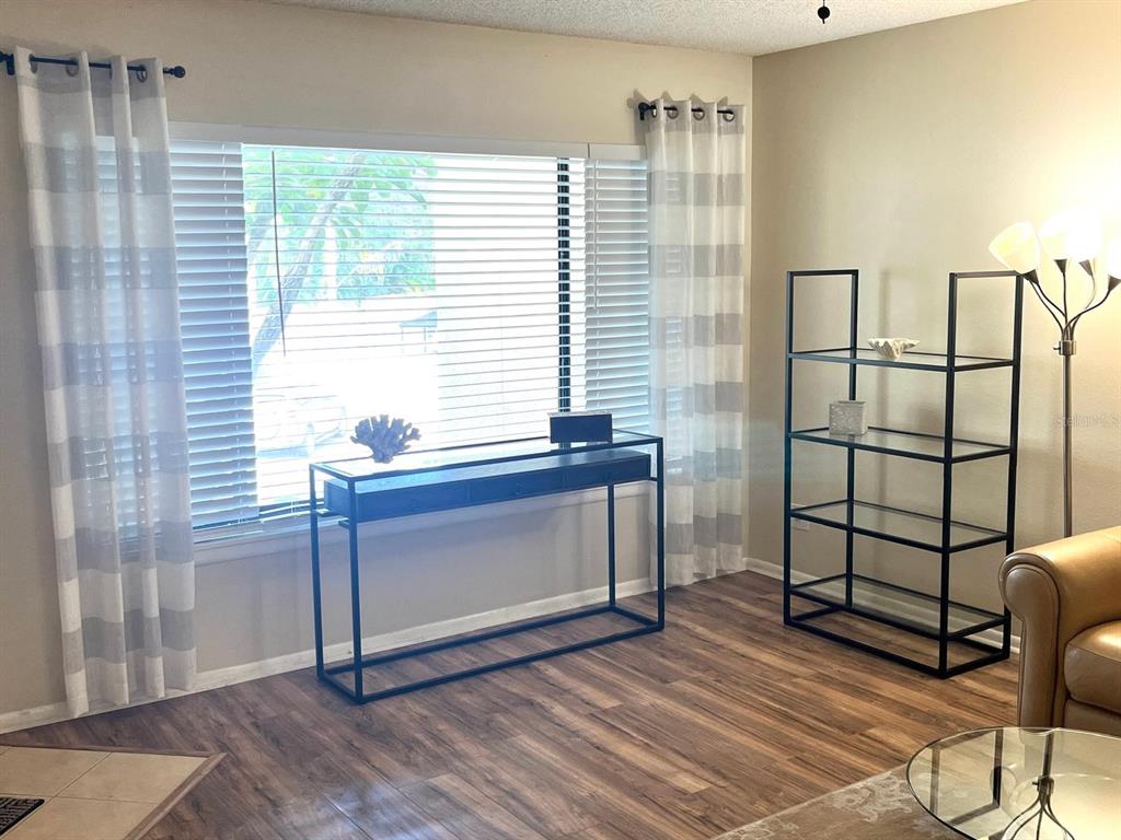 1550 South Belcher Road, Unit 524 Clearwater, FL 33764 - Photo 4 of 45 a view of room with window and wooden floor