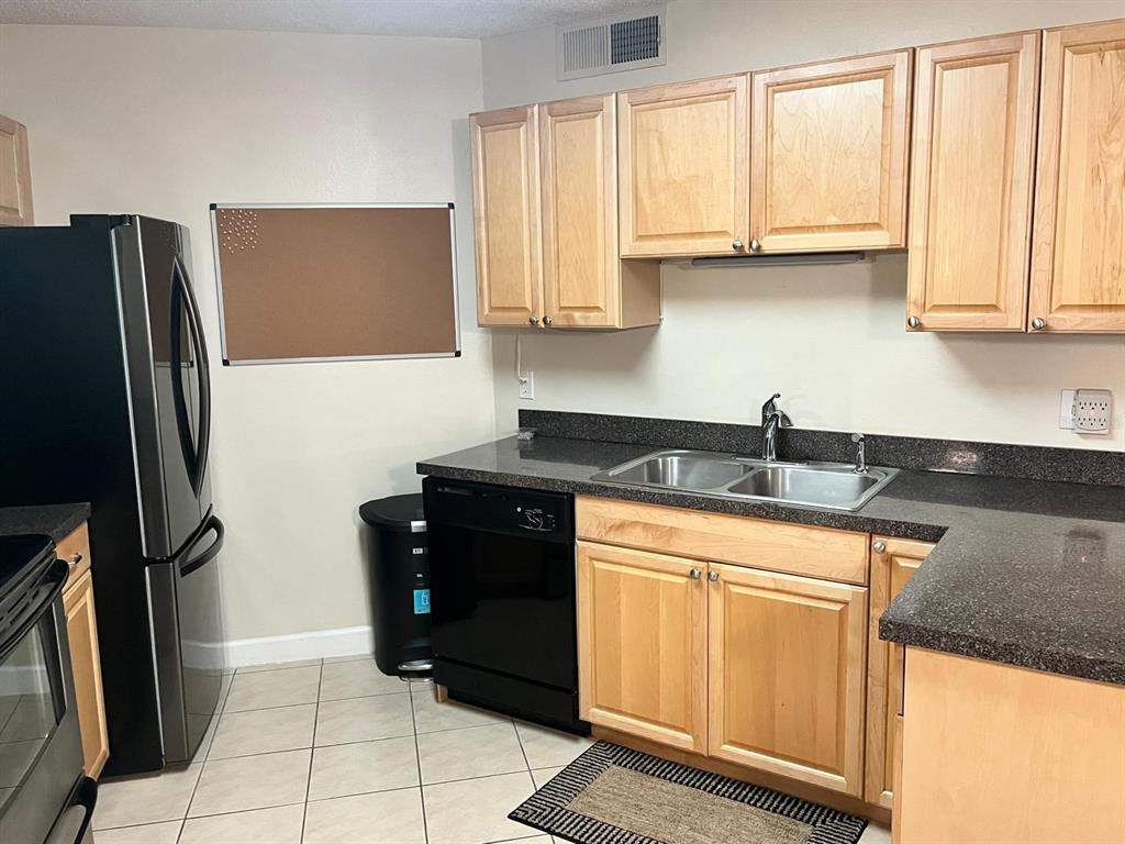 1550 South Belcher Road, Unit 524 Clearwater, FL 33764 - Photo 10 of 45 a kitchen with stainless steel appliances granite countertop a refrigerator and a sink