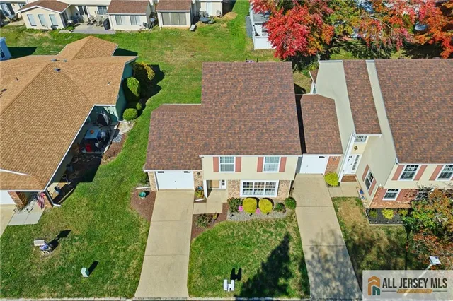 an aerial view of multiple houses with yard