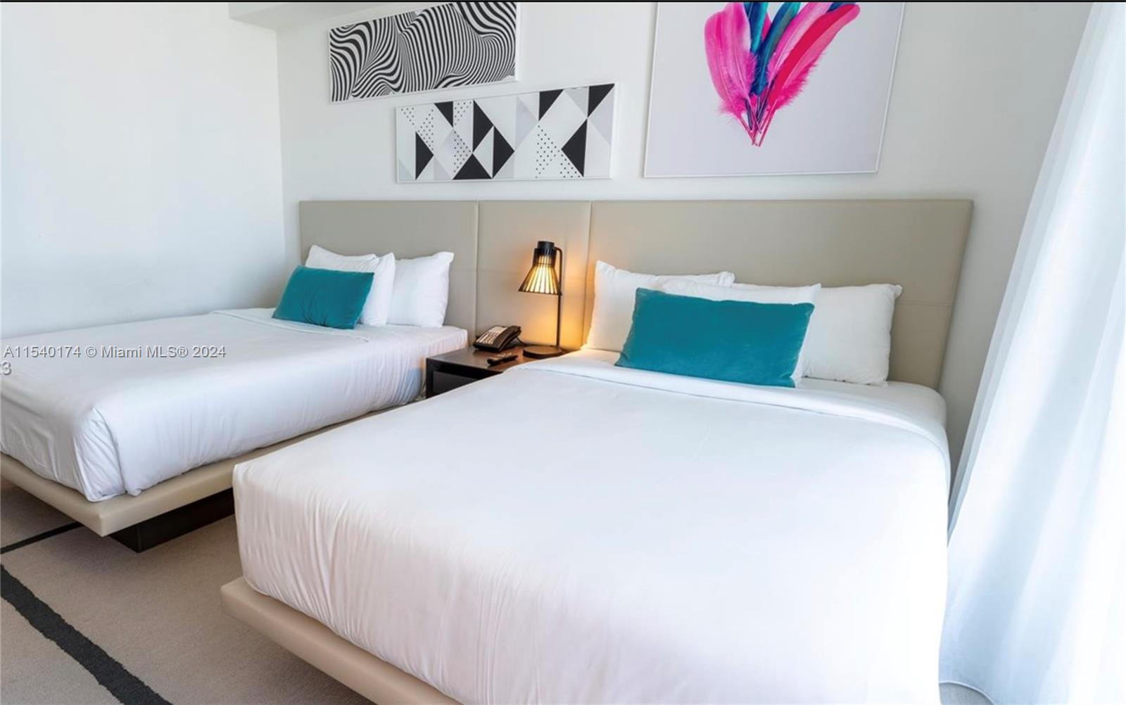 4010 South Ocean Drive, Unit R703 Hollywood, FL 33019 - Photo 12 of 37 a bedroom with a bed and painting on the wall