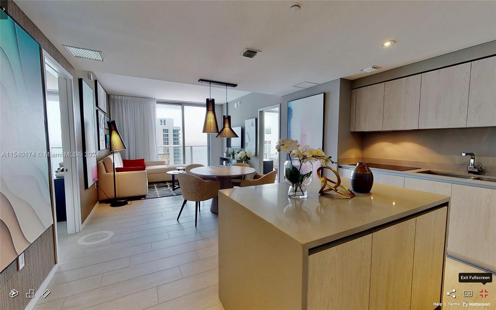 4010 South Ocean Drive, Unit R703 Hollywood, FL 33019 - Photo 3 of 37 a open kitchen with stainless steel appliances granite countertop a sink dishwasher and a refrigerator with wooden floor