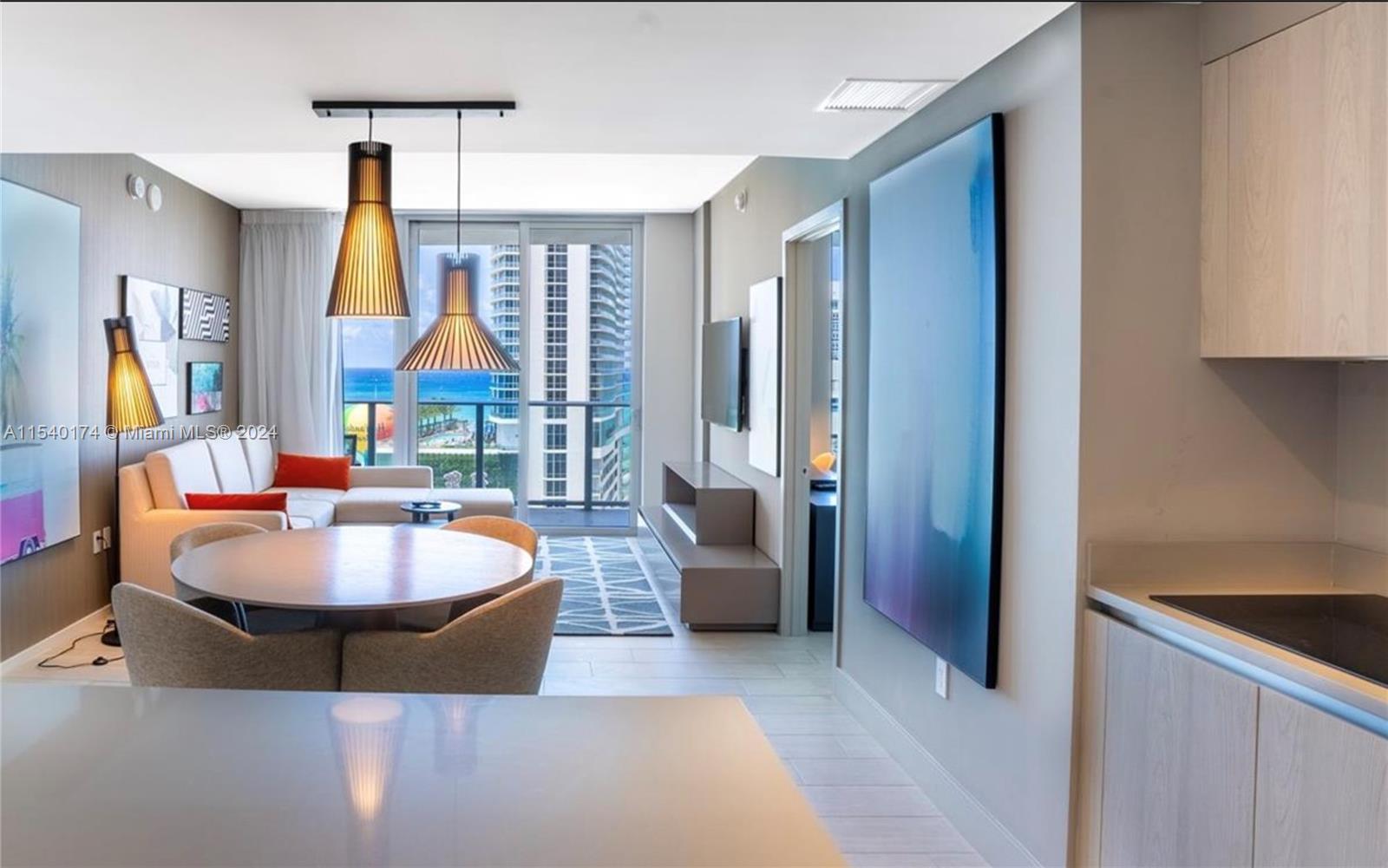 4010 South Ocean Drive, Unit R703 Hollywood, FL 33019 - Photo 5 of 37 a living room with fireplace and a chandelier