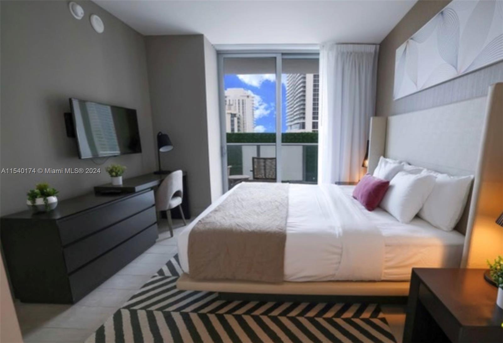 4010 South Ocean Drive, Unit R703 Hollywood, FL 33019 - Photo 9 of 37 a bedroom with a bed and window