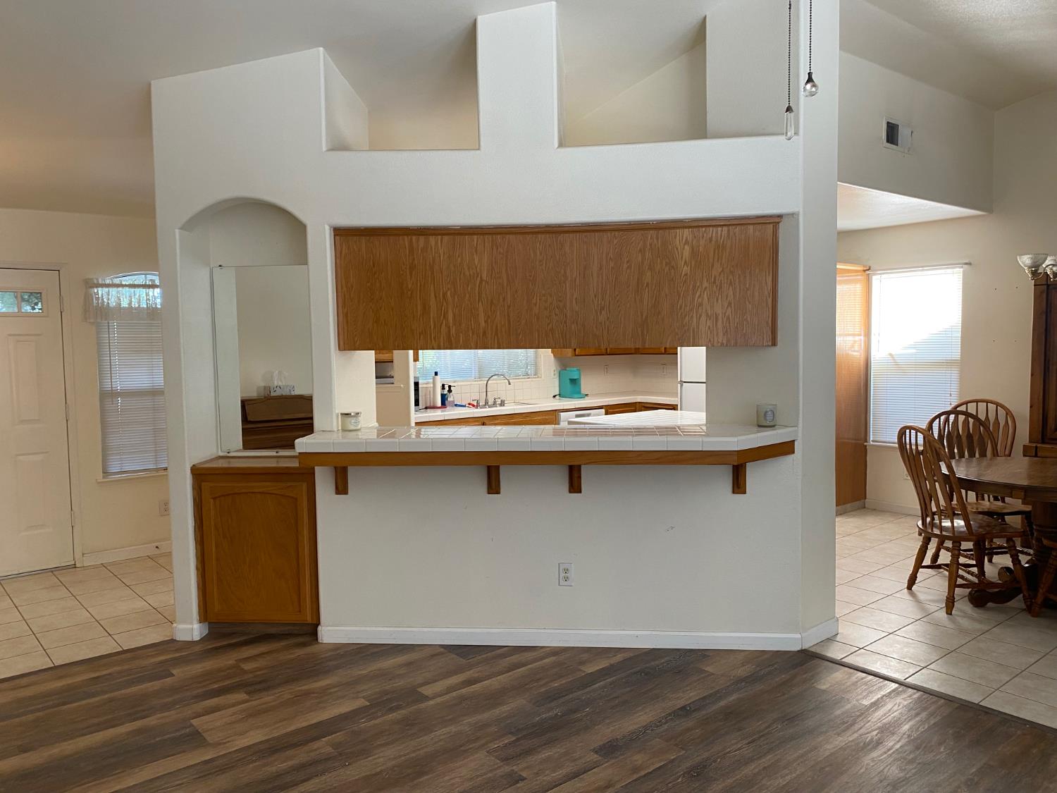 609 Merlot Avenue Madera, CA 93637 - Photo 12 of 45 a kitchen with a refrigerator and table chair