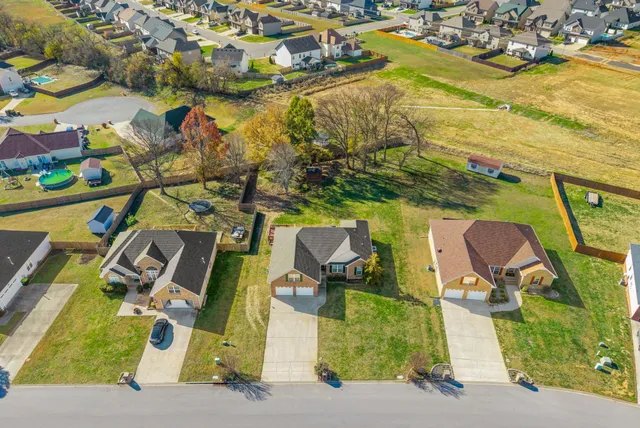 an aerial view of a house with a swimming pool