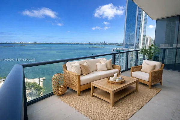 a balcony with furniture and a potted plant