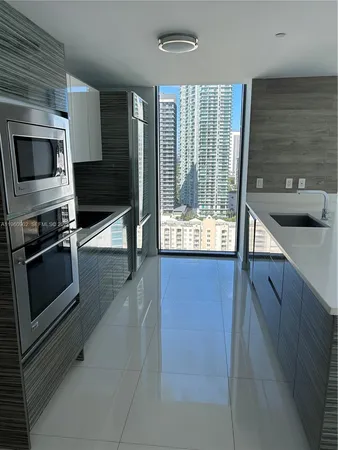 a kitchen with stainless steel appliances granite countertop a refrigerator and a stove
