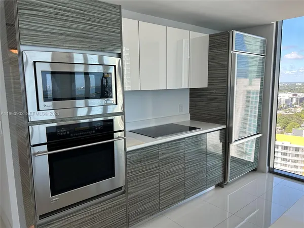 a kitchen with granite countertop cabinets stainless steel appliances and counter space