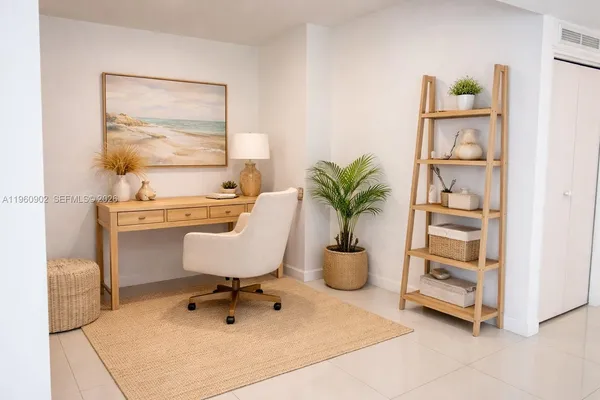 a room with a chair and potted plant