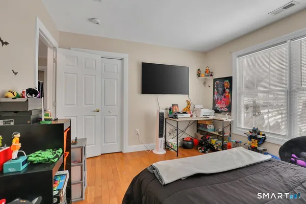 a bedroom with a bed and a flat screen tv
