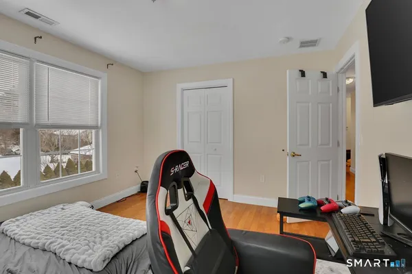 a bedroom with furniture and a flat screen tv