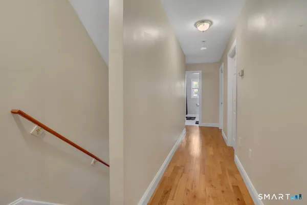 a view of a hallway with wooden floor