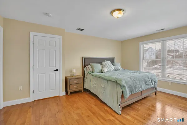 a spacious bedroom with a bed and a window