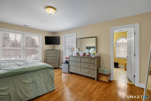 a bed room with a bed and a television