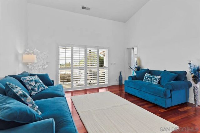 a living room with furniture wooden floor and a fireplace