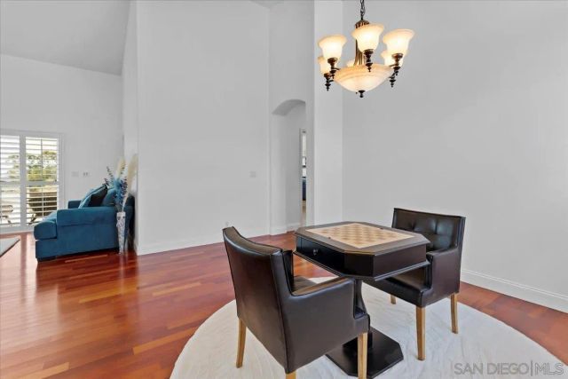 a view of a dining room with furniture and chandelier