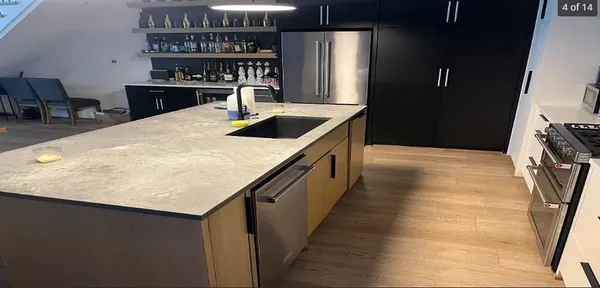 a kitchen with a counter top and outdoor space